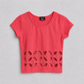Red top with cut-out design on a gray background