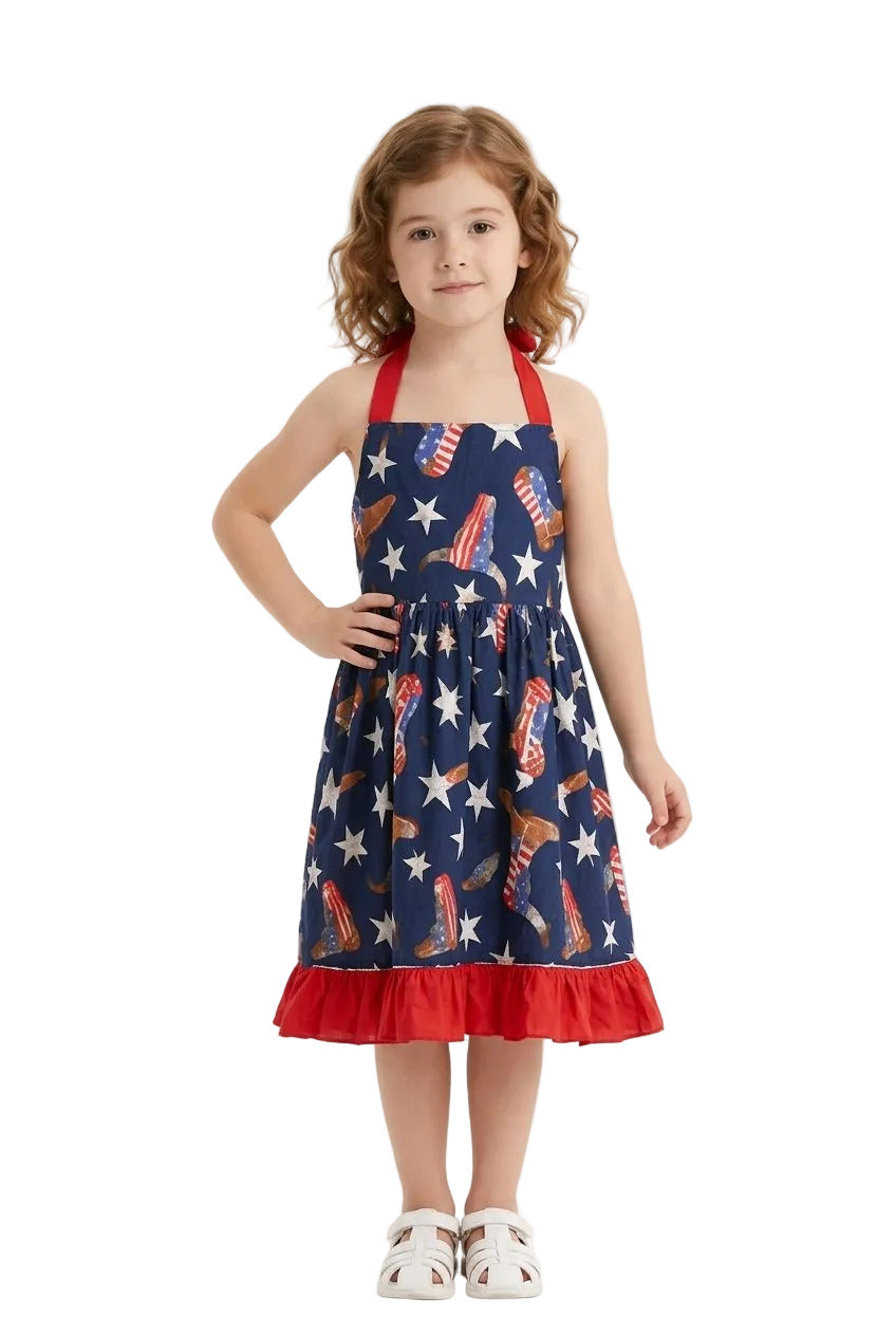 Young girl wearing a red, white, and blue dress with star and stripe pattern on a white background