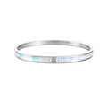 Silver bracelet with a central gemstone on a white background
