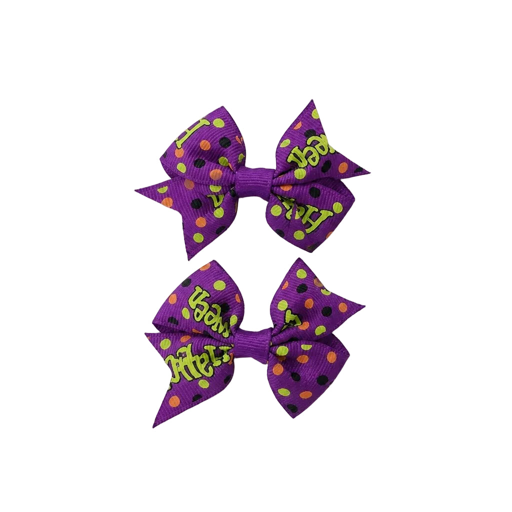 Two purple hair bows with colorful polka dots and text on a light gray background