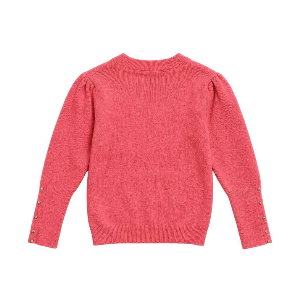 A coral pink knit sweater shown from the back, featuring puffed long sleeves with decorative metallic buttons along the cuffs, laid flat on a light gray background.