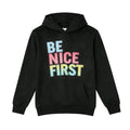 Black hoodie with 'BE NICE FIRST' text in colorful letters on a white background