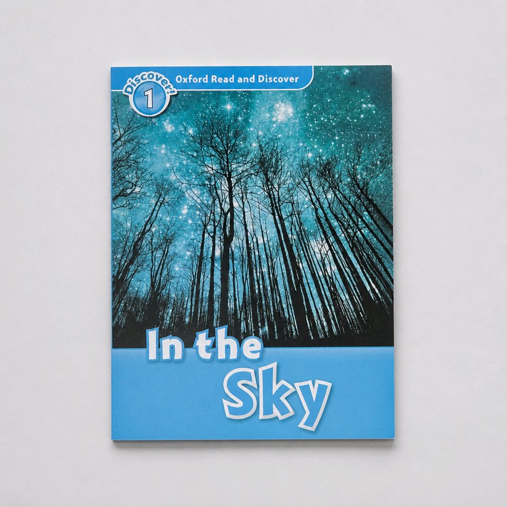 A children's book titled 'In the Sky' from the 'Oxford Read and Discover' series, featuring a cover illustration of silhouetted trees against a starry blue night sky, set against a light gray background.