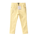 Yellow jeans with a tag on a light gray background