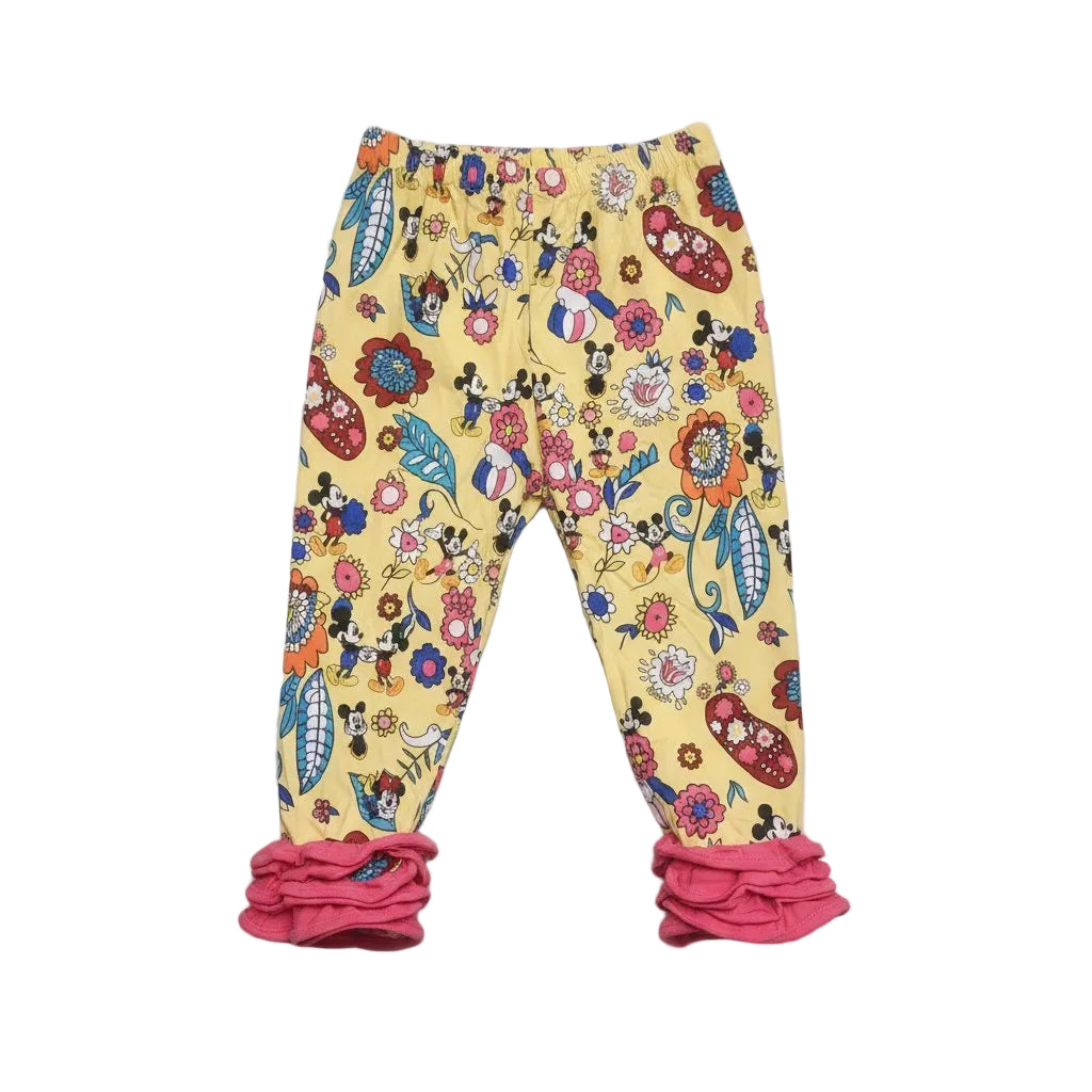 Colorful children's pants with floral and character patterns on a gray background