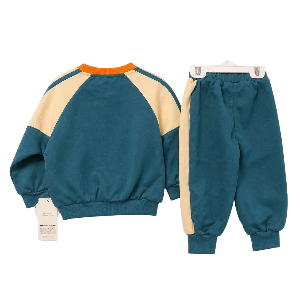 A two-piece children's outfit set consisting of a long-sleeve colorblock sweatshirt and matching jogger pants, laid flat on a light gray background. The sweatshirt features a teal body, cream-colored shoulder panels, and an orange collar.
