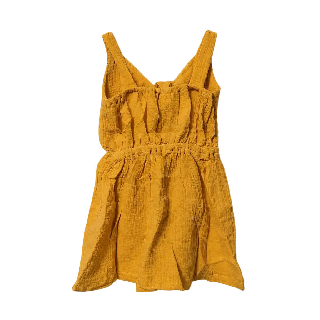Yellow dress with straps on a light gray background