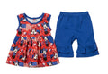 Red dress with character print and blue shorts on a gray background