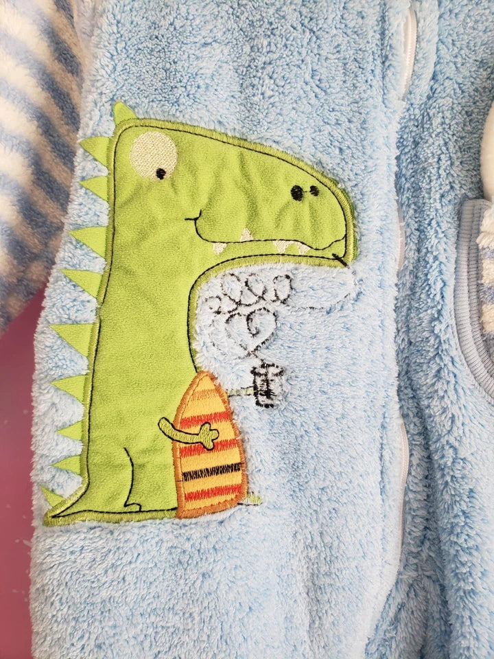 Children's towel with a green dinosaur design on a blue background
