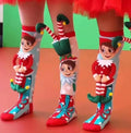 A pair of colorful Christmas-themed socks featuring character designs and festive decorations. Get into the holiday spirit with our 3D Christmas Socks Elf & Santa! One size fits all, making them perfect for everyone. Order now!