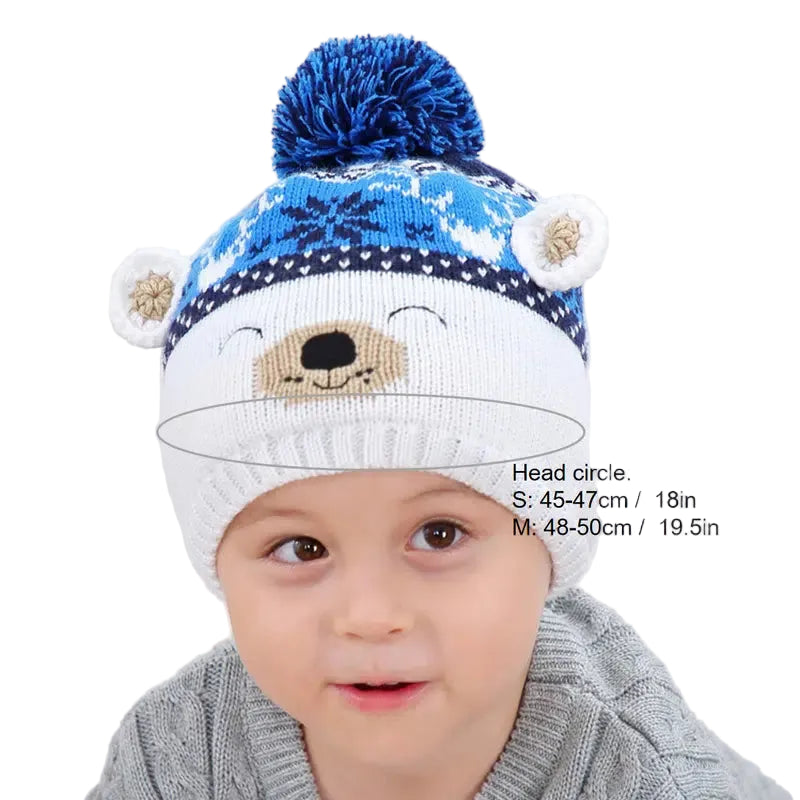 A child wearing a winter beanie with a cute bear face design on a blue and white background, with the hat's head circle measurements displayed.